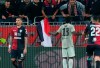 Cagliari fans shout to Juventus's Moise Kean, center with back to camera, after he scored his side's second goal during a Serie A soccer match between Cagliari and Juventus at the Sardegna Arena Stadium in Cagliari, Italy, Tuesday, April 2, 2019. Cagliari fans shouted racist chants at Kean after the 19-year-old scored in the 85th minute, the chants were so bad that Cagliari captain Luca Ceppitelli rushed in to protect the youngster and ask the fans to stop. (Fabio Murru/ANSA via AP)