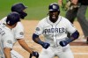 CORRECTS INNING TO SECOND INNING INSTEAD OF 22ND INNING - San Diego Padres' Franmil Reyes, right, reacts with teammates after hitting a two-run home run during the second inning of a baseball game against the Seattle Mariners, Tuesday, April 23, 2019, in San Diego. (AP Photo/Gregory Bull)
