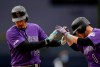 Colorado Rockies' Nolan Arenado, left, is greeted by Garrett Hampson after hitting a two-run home run during the first inning of the team's baseball game against the San Diego Padres, Tuesday, April 16, 2019, in San Diego. (AP Photo/Gregory Bull)