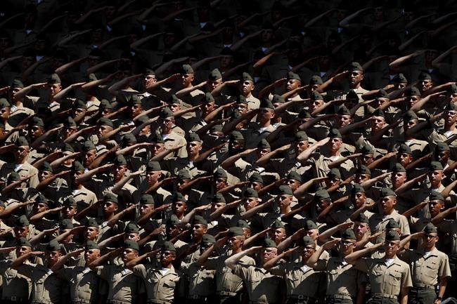Recruits from Marine Corps Recruit Depot San Diego salute during the national anthem before a baseball game between the San Diego Padres and the Colorado Rockies, Sunday, Sept. 8, 2019, in San Diego. (AP Photo/Gregory Bull)