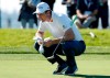 Justin Rose, of England, looks over his line before putting on the first greeb of the South Course at Torrey Pines Golf Course during the third round of the Farmers Insurance golf tournament Saturday, Jan. 26, 2019, in San Diego. (AP Photo/Gregory Bull)