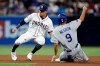 San Diego Padres second baseman Luis Urias, left, waits for the throw before tagging out Los Angeles Dodgers' Kristopher Negron (9), who was caught stealing second base during the fourth inning of a baseball game Wednesday, Sept. 25, 2019, in San Diego. (AP Photo/Gregory Bull)