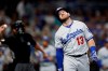 Los Angeles Dodgers' Max Muncy (13) reacts after being hit on the arm while batting during the fifth inning of the team's baseball game against the San Diego Padres on Wednesday, Aug. 28, 2019, in San Diego. (AP Photo/Gregory Bull)