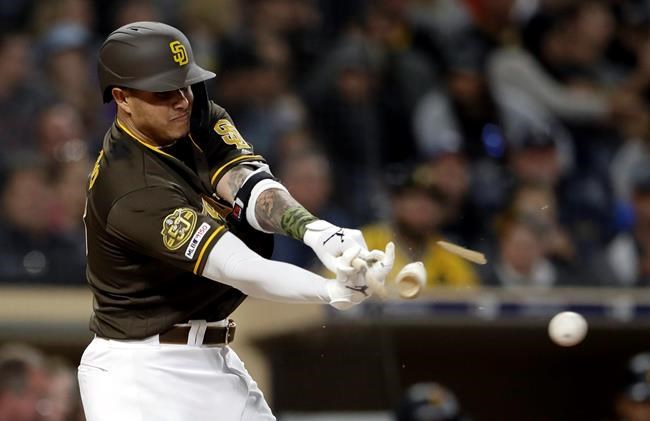 San Diego Padres' Manny Machado breaks his bat as he hits into a double play during the third inning of the team's baseball game against the Pittsburgh Pirates, Friday, May 17, 2019, in San Diego. (AP Photo/Gregory Bull)