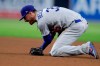 Los Angeles Dodgers first baseman Cody Bellinger reacts after straining his arm trying to field a ground ball hit for a single by San Diego Padres' Eric Hosmer during the fourth inning of a baseball game Friday, May 3, 2019, in San Diego. (AP Photo/Gregory Bull)