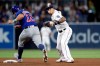 San Diego Padres third baseman Manny Machado, right, throws to first after forcing out Chicago Cubs' Kyle Schwarber, left, at second during the fifth inning of a baseball game Tuesday, Sept. 10, 2019, in San Diego. Anthony Rizzo was safe at first. (AP Photo/Gregory Bull)