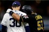 Pittsburgh Pirates' Melky Cabrera, right, embraces San Diego Padres first baseman Eric Hosmer after being walked during the sixth inning of a baseball game Thursday, May 16, 2019, in San Diego. (AP Photo/Gregory Bull)