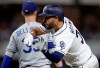 San Diego Padres' Eric Hosmer, right, reacts after hitting an RBI single as Los Angeles Dodgers right fielder Cody Bellinger stands on first base, left, during the fourth inning of a baseball game, Monday, Aug. 26, 2019, in San Diego. (AP Photo/Gregory Bull)
