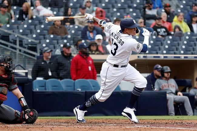 San Diego Padres' Manny Machado follows through on a single during the sixth inning of the team's baseball game against the Arizona Diamondbacks, Wednesday, May 22, 2019, in San Diego. (AP Photo/Gregory Bull)