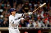 San Diego Padres' Manny Machado watches his grand slam hit during the sixth inning of a baseball game against the Philadelphia Phillies, Monday, June 3, 2019, in San Diego. (AP Photo/Gregory Bull)