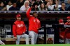Cincinnati Reds' Yasiel Puig, center, gestures from the dugout during the seventh inning of the team's baseball game against the San Diego Padres, Thursday, April 18, 2019, in San Diego. (AP Photo/Gregory Bull)