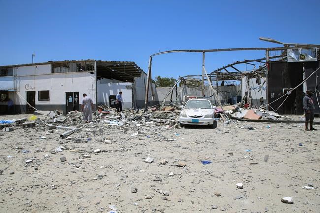 Debris covers the ground and an emergency vehicle after an airstrike at a detention center in Tajoura, east of Tripoli in Libya, Wednesday, July 3, 2019. An airstrike hit the detention center for migrants early Wednesday, killing several. (AP Photo/Hazem Ahmed)