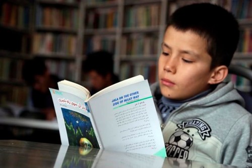 In this Tuesday, March 19, 2019, an Afghan boy studies at the Rahila library, in Kabul, Afghanistan. Launched in February by the Afghanistan Human Rights and Democracy Organization, the center seeks to salvage, protect and share memories and stories of civilian victims of the country's four decades of war. (AP Photo/Rahmat Gul)