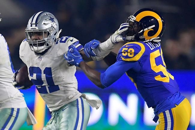 Dallas Cowboys running back Ezekiel Elliott pushes off Los Angeles Rams inside linebacker Cory Littleton during the first half in an NFL divisional football playoff game Saturday, Jan. 12, 2019, in Los Angeles. (AP Photo/Mark J. Terrill)