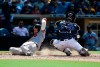 Atlanta Braves' Josh Donaldson, left, slides into home for a run ahead of the catch by San Diego Padres catcher Francisco Mejia during the eighth inning of a baseball game off a single by Nick Markakis in San Diego, Sunday, July 14, 2019. (AP Photo/Kelvin Kuo)