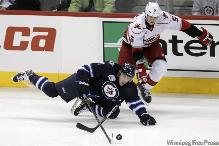 Mike Deal / Winnipeg Free Press
Winnipeg Jets' Jason Jaffray (41) tries to keep control of the puck after getting checked by Carolina Hurricanes Bryan Allen (5) in the third period.