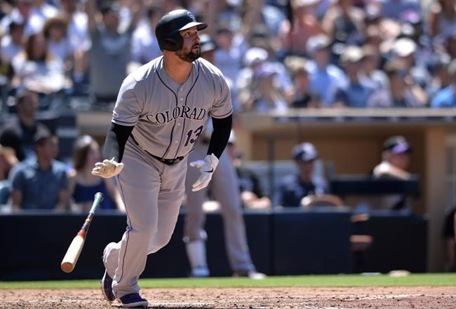 Colorado Rockies' Yonder Alonso watches his two-run home run during the sixth inning of a baseball game against the San Diego Padres, Sunday, Aug. 11, 2019, in San Diego. (AP Photo/Orlando Ramirez)