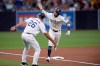 San Diego Padres' Fernando Tatis Jr., right, is congratulated by Glenn Hoffman after hitting a home run during the first inning of the team's baseball game against the Colorado Rockies on Thursday, Aug. 8, 2019, in San Diego. (AP Photo/Orlando Ramirez)