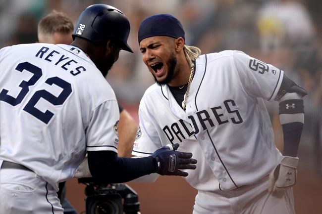San Diego Padres' Franmil Reyes (32) is congratulated by Fernando Tatis Jr. after hitting a home run during the first inning of a baseball game against the Baltimore Orioles, Monday, July 29, 2019, in San Diego. (AP Photo/Orlando Ramirez)