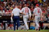 St. Louis Cardinals' Marcell Ozuna, center, leaves the field accompanied by a trainer and Mike Shildt during the third inning of a baseball game against the San Diego Padres, Friday, June 28, 2019, in San Diego. (AP Photo/Orlando Ramirez)