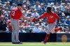 Washington Nationals' Howie Kendrick, right, is congratulated by third base coach Bob Henley after hitting a home run during the eighth inning of a baseball game against the San Diego Padres, Sunday, June 9, 2019, in San Diego. (AP Photo/Orlando Ramirez)