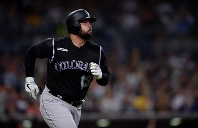 Colorado Rockies' Yonder Alonso watches his two-run home run during the seventh inning of a baseball game against the San Diego Padres, Saturday, Aug. 10, 2019, in San Diego. (AP Photo/Orlando Ramirez)