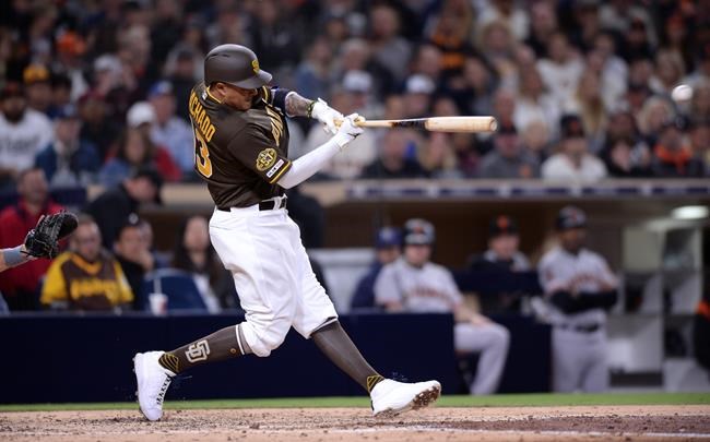 San Diego Padres' Manny Machado singles during the fifth inning of the team's baseball game against the San Francisco Giants on Friday, March 29, 2019, in San Diego. (AP Photo/Orlando Ramirez)