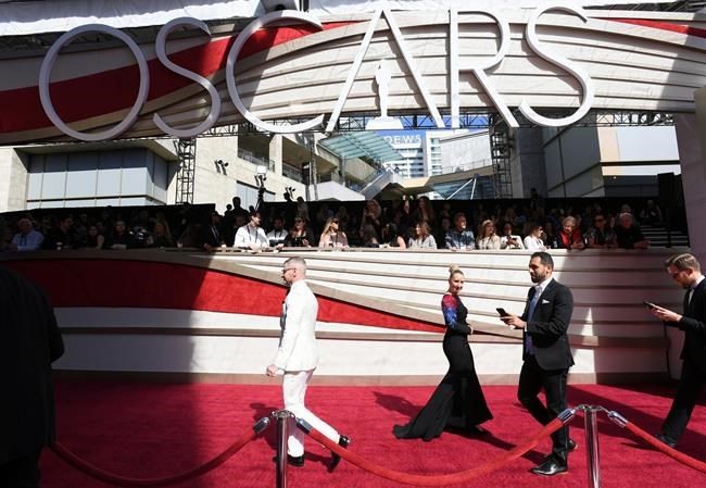 Media walk on the red carpet before the Oscars on Sunday, Feb. 24, 2019, at the Dolby Theatre in Los Angeles. (Photo by Jordan Strauss/Invision/AP)