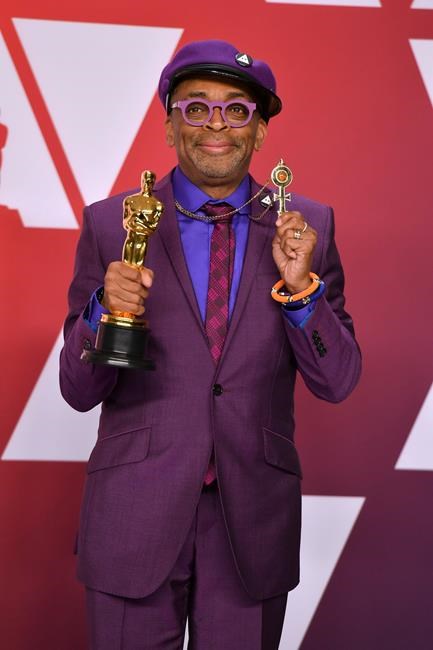 Spike Lee poses with the award for best adapted screenplay for
