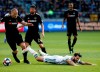 Portland Timbers midfielder Diego Valeri, front right, of Argentina, falls after being tackled by Los Angeles FC defender Jordan Harvey, left, in the first half of an MLS soccer match in Los Angeles, Sunday, March 10, 2019. (AP Photo/Ringo H.W. Chiu)