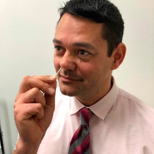In this Monday, Feb. 11, 2019 photo provided by Dr. Susan Huang of the University of California, Irvine School of Medicine, researcher Raheeb Saavedra demonstrates how to use a medicated ointment for a study on preventing superbug infections. Hospitalized patients who harbor superbugs can cut their risk of developing full-blown infections if they swab medicated goo in their nose and use special soap and mouthwash for six months after going home, a study published on Wednesday, Feb. 13, 2019 finds. (Susan Huang via AP)