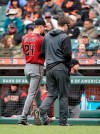 Arizona Diamondbacks pitcher Luke Weaver, left, walks off the field with a trainer during the sixth inning against the San Francisco Giants of a baseball game in San Francisco, Sunday, May 26, 2019. (AP Photo/Tony Avelar)