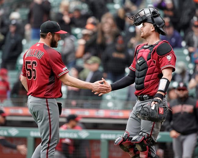 Arizona Diamondbacks pitcher Greg Holland (56) is congratulated by catcher Carson Kelly after a victory over the San Francisco Giants in a baseball game in San Francisco, Sunday, May 26, 2019. (AP Photo/Tony Avelar)