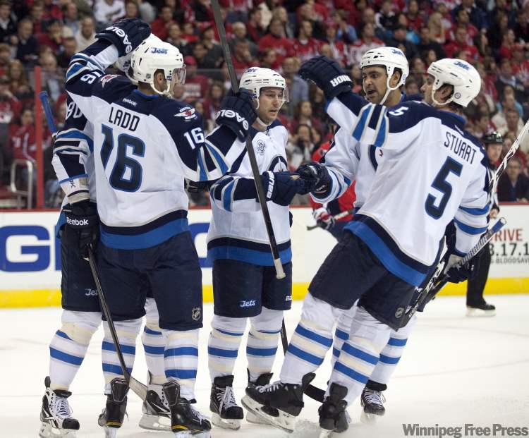 Chuck Myers / Tribune Media / MCT
Winnipeg Jets' left-winger Andrew Ladd (16) celebrates with teammates following his goal against the Washington Capitals in the first period Wednesday.