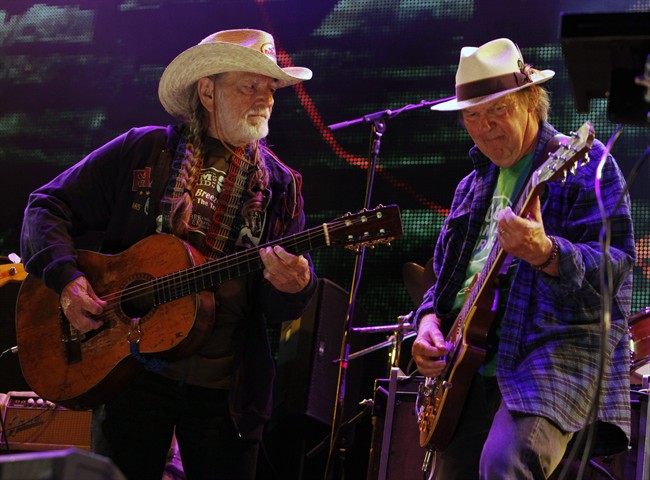 FILE - In this Sept. 22, 2012 file photo Neil Young, right, and Willie Nelson perform during the Farm Aid 2012 concert at Hersheypark Stadium in Hershey, Pa. Opponents of a proposed pipeline that would carry oil from Canada south to the Gulf Coast said Monday, Aug. 18, 2014 that Nelson and Young will headline a concert on Sept. 27 on a farm near Neligh in northeast Nebraska. (AP Photo/Jacqueline Larma, File)