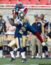Paul Chiasson / the canadian press
Als receiver Brandon London snags a pass over Bombers defensive back Jerry-Ralph Jules on Thursday night.
