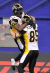 Paul Chiasson / The Canadian Press
Hamilton Tiger-Cats running back Avon Cobourne leaps into the arms of teammate wide receiver Matt Carter following a touchdown against the Montreal Alouettes during fourth quarter CFL East Division semifinal football action Sunday in Montreal. The Tiger-Cats beat the Alouettes 52-44 and will face the Winnipeg Blue Bombers in the East Division final.