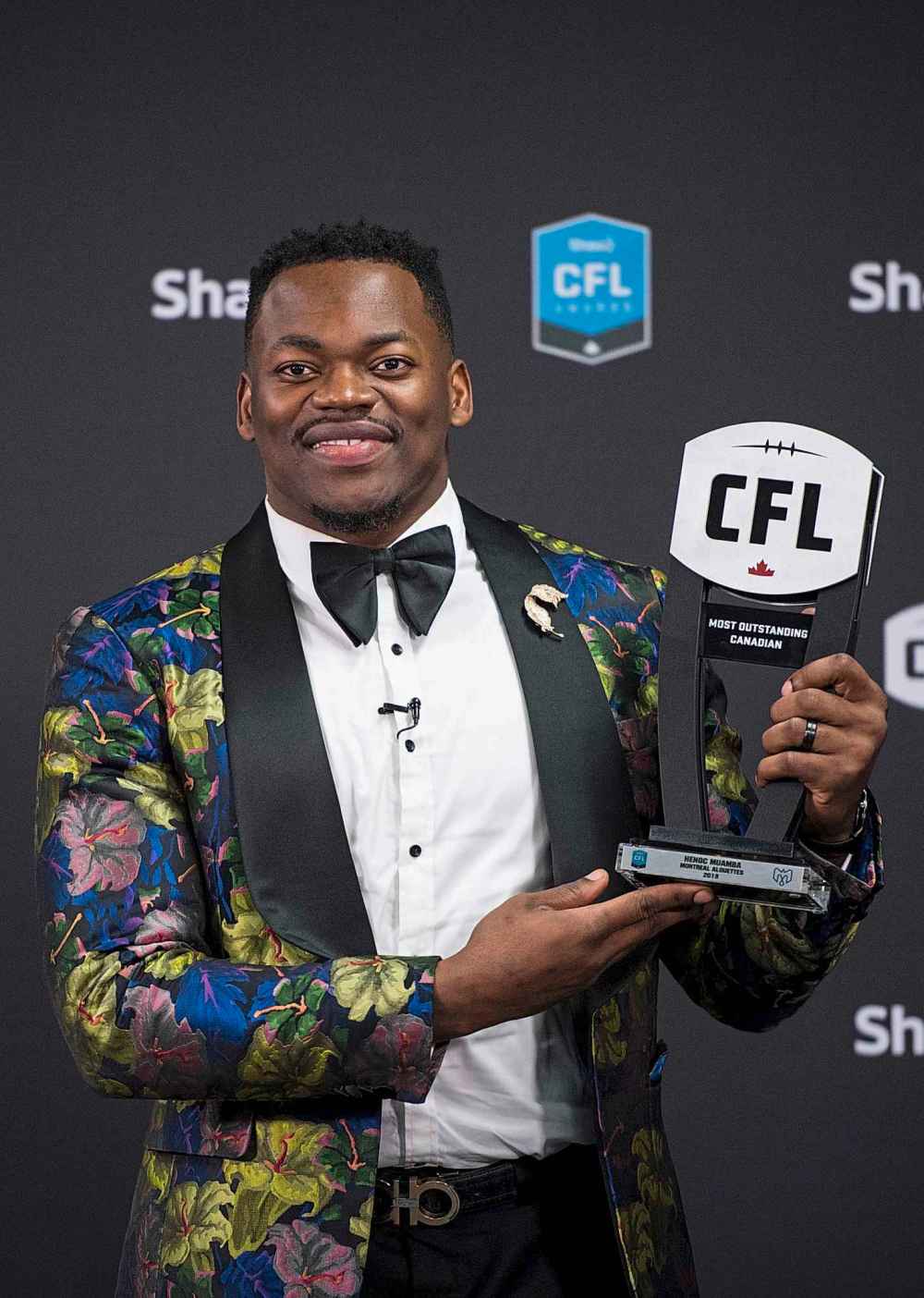 THE CANADIAN PRESS/Nathan Denette
Montreal Alouettes linebacker Henoc Muamba with the trophy for the most outstanding Canadian award at the CFL Awards during the CFL's Grey Cup week in Calgary, Thursday.
