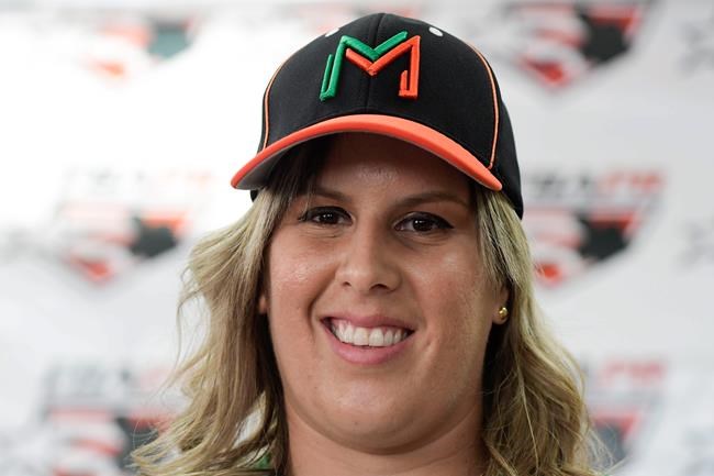 First baseman and member of the National Women's Baseball Team, Diamilette Quiles Alicea, is presented as the first female player to sign with The Utuado Highlanders, one of the teams that participate in the Superior Double A Baseball League, in San Juan, Puerto Rico, Thursday, May 16, 2019. For the first time in Puerto Rico's history, a woman is set to play in an otherwise all-male baseball tournament organized by a popular semi-pro league.(AP Photo/Carlos Giusti)