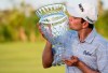 Martin Trainer of California kisses the championship cup after winning the Puerto Rico Open PGA golf tournament in Rio Grande, Puerto Rico, Sunday, Feb. 24, 2019. (AP Photo/Carlos Giusti)