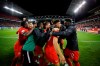 Canada midfielder Alphonso Davies (12) looks at forward Lucas Cavallini (19) as they celebrate Cavallini's goal during the second half of CONCACAF Nations League soccer action against the United States, in Toronto, Tuesday, Oct. 15, 2019. THE CANADIAN PRESS/Cole Burston