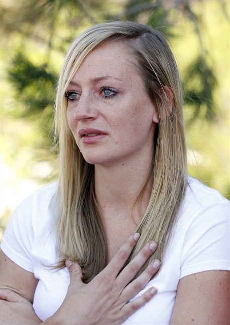 Amanda Lindgren cries as she speaks about her boyfriend Alex Teves, at the Arapahoe County Courthouse, Monday, July 23, 2012, in Centennial, Colo. Teves was one of the 12 people killed in the shooting attack early Friday at an Aurora, Colo., theater during a showing of the Batman movie,