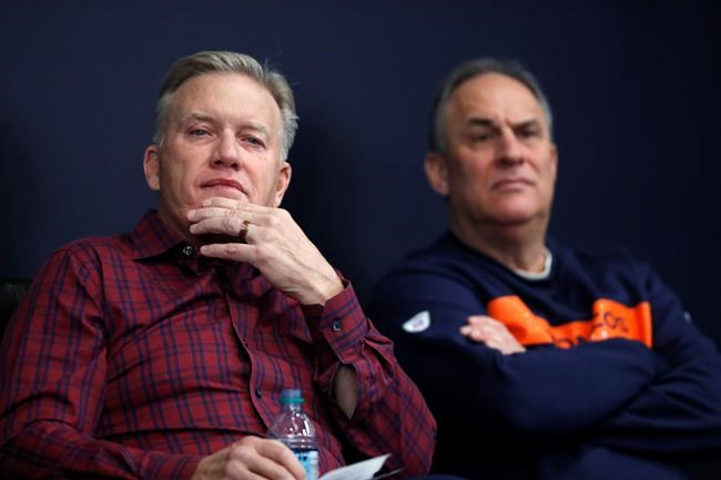Denver Broncos general manager John Elway, left, and head coach Vic Fangio listen at as quarterback Joe Flacco speaks news conference at the NFL football team's headquarters, Friday, March 15, 2019, in Englewood, Colo. (AP Photo/David Zalubowski)