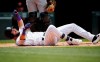 Colorado Rockies' David Dahl rolls on the ground after fouling a pitch off his foot while facing San Francisco Giants starting pitcher Shaun Anderson in the first inning of a baseball game Wednesday, July 17, 2019, in Denver. Dahl remained in the game. (AP Photo/David Zalubowski)
