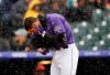 Colorado Rockies' Nolan Arenado cleans snow out of his ear while batting against the San Francisco Giants in the first inning of a baseball game Thursday, May 9, 2019, in Denver. (AP Photo/David Zalubowski)