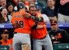 Baltimore Orioles' Hanser Alberto, right, congratulates Renato Nunez after Nunez's solo home run off Colorado Rockies starting pitcher Kyle Freeland in the third inning of a baseball game Saturday, May 25, 2019, in Denver. (AP Photo/David Zalubowski)