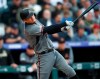 Arizona Diamondbacks' Wilmer Flores follows the flight of his RBI-double off Colorado Rockies starting pitcher Kyle Freeland in the third inning of a baseball game Saturday, May 4, 2019, in Denver. (AP Photo/David Zalubowski)