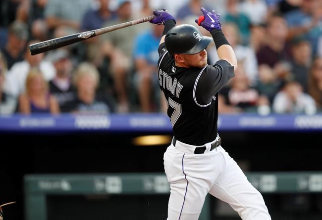 Colorado Rockies' Trevor Story follows through on a two-run home run off San Francisco Giants starting pitcher Madison Bumgarner during the third inning of a baseball game Saturday, Aug. 3, 2019, in Denver. (AP Photo/David Zalubowski)