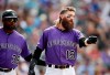 As Colorado Rockies third base coach Stu Cole, left, looks on, Rockies' Charlie Blackmon argues with first base umpire Scott Barry after Barry ruled that Blackmon's ground ball was fair - not foul - and that he was out to end the seventh inning of a baseball game against the Arizona Diamondbacks, Sunday, May 5, 2019, in Denver. (AP Photo/David Zalubowski)
