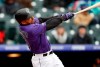 Colorado Rockies' Ian Desmond hits a two-run home run of San Francisco Giants starting pitcher Derek Holland in the second inning of a baseball game Thursday, May 9, 2019, in Denver. (AP Photo/David Zalubowski)